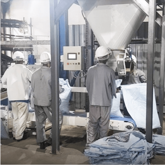 Bagging Scale with three floor workers in grey workman's gear